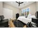 This bedroom features wood floors, a ceiling fan, and mountain views from the window at 4417 W El Cortez Trl, Phoenix, AZ 85083