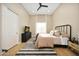This bedroom features wood floors, a ceiling fan, and a bright window with drapes at 4417 W El Cortez Trl, Phoenix, AZ 85083