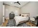 This bedroom features wood floors, a ceiling fan, and natural lighting from two windows at 4417 W El Cortez Trl, Phoenix, AZ 85083