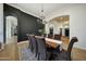 Dining room with dark accent wall, hardwood floors, and seating for eight at 4417 W El Cortez Trl, Phoenix, AZ 85083