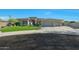 A well-kept home with a three-car garage, desert landscaping, circular driveway, and clean modern architecture at 4417 W El Cortez Trl, Phoenix, AZ 85083
