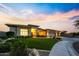 Inviting modern home with a manicured lawn and circular driveway set against a sunset sky at 4417 W El Cortez Trl, Phoenix, AZ 85083