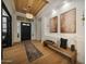 Elegant foyer featuring a wood plank ceiling, chandelier, and a bench with pillows at 4417 W El Cortez Trl, Phoenix, AZ 85083