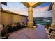 Inviting covered porch with cozy chairs, decorative plants, and a tranquil outdoor seating area at 4417 W El Cortez Trl, Phoenix, AZ 85083