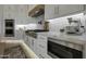 Gourmet kitchen features professional grade stainless steel appliances, custom cabinetry, and stylish backsplash at 4417 W El Cortez Trl, Phoenix, AZ 85083