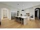 Modern kitchen with hardwood floors, stainless steel appliances, and a center island with seating at 4417 W El Cortez Trl, Phoenix, AZ 85083