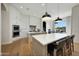 Bright, open kitchen with white cabinetry, large island with seating, and modern pendant lighting at 4417 W El Cortez Trl, Phoenix, AZ 85083