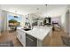 Open concept kitchen with quartz countertops, stainless steel appliances, and easy access to outdoor dining space at 4417 W El Cortez Trl, Phoenix, AZ 85083