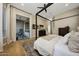 Elegant main bedroom with dark wood floors, canopy bed, and an attached private balcony at 4417 W El Cortez Trl, Phoenix, AZ 85083