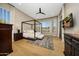 Spacious main bedroom with wood floors, canopy bed, ceiling fan, and natural light at 4417 W El Cortez Trl, Phoenix, AZ 85083