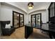 Stylish office with hardwood floors, black marble desk, and black french doors at 4417 W El Cortez Trl, Phoenix, AZ 85083
