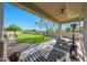 Covered patio with outdoor dining and view of the expansive artificial lawn at 4417 W El Cortez Trl, Phoenix, AZ 85083