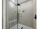 This walk-in shower features gray tile, a rainfall showerhead, and built-in shower bench at 4417 W El Cortez Trl, Phoenix, AZ 85083