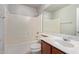Bright bathroom with a bathtub, shower, white tiling, and a vanity at 45018 W Sage Brush Dr, Maricopa, AZ 85139