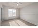 Comfortable bedroom featuring neutral walls, plush carpeting, a ceiling fan and natural light at 45018 W Sage Brush Dr, Maricopa, AZ 85139