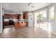 Open-concept kitchen featuring cherry wood cabinets, stainless steel appliances and a breakfast bar perfect for entertaining at 45018 W Sage Brush Dr, Maricopa, AZ 85139