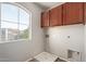Convenient laundry room with washer/dryer hookups and a window with natural light at 45018 W Sage Brush Dr, Maricopa, AZ 85139