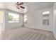 Spacious living room with ample natural light, carpet flooring, and neutral walls, perfect for relaxing at 45018 W Sage Brush Dr, Maricopa, AZ 85139