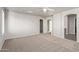 Large main bedroom with plush carpet, bright windows, and an ensuite bathroom at 45018 W Sage Brush Dr, Maricopa, AZ 85139