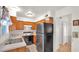 Functional kitchen layout with a stainless steel refrigerator and wood cabinetry at 4630 N 68Th St # 265, Scottsdale, AZ 85251