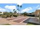 Shuffleboard court with palm trees, lush landscaping, and nearby buildings at 4630 N 68Th St # 265, Scottsdale, AZ 85251