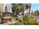 A sign for Camelback House Condominiums, surrounded by colorful flowers and lush greenery at 4630 N 68Th St # 265, Scottsdale, AZ 85251