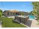 An incredible outdoor living space featuring a pool, a patio, and plush artificial turf at 4714 E Lewis Ave, Phoenix, AZ 85008