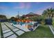 Serene backyard featuring a sparkling pool, lush landscaping, and a comfortable lounge area for relaxation at 4714 E Lewis Ave, Phoenix, AZ 85008