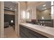 Bathroom featuring double sinks with modern faucets and a view into the office area at 4714 E Lewis Ave, Phoenix, AZ 85008