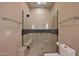 Shower featuring glass surround, shower seat, and modern fixtures at 4714 E Lewis Ave, Phoenix, AZ 85008