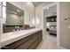 Bathroom featuring double sinks with modern faucets and a view into the bedroom area at 4714 E Lewis Ave, Phoenix, AZ 85008