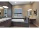 Modern bathroom featuring a soaking tub, stylish fixtures, and contemporary design elements at 4714 E Lewis Ave, Phoenix, AZ 85008