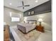 Stylish bedroom with a comfortable bed, ceiling fan, and neutral decor, creating a relaxing atmosphere at 4714 E Lewis Ave, Phoenix, AZ 85008