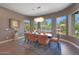 Elegant dining room with modern chandelier, views of the backyard, and comfortable seating for six at 4714 E Lewis Ave, Phoenix, AZ 85008