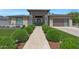Inviting entrance with a herringbone walkway, lush landscaping, and a stylish front door at 4714 E Lewis Ave, Phoenix, AZ 85008