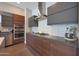 Modern kitchen featuring stainless steel appliances, sleek cabinets, and a stylish range hood at 4714 E Lewis Ave, Phoenix, AZ 85008
