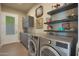 Well-equipped laundry room with modern washer and dryer, ample storage, and convenient layout at 4714 E Lewis Ave, Phoenix, AZ 85008