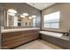 Modern main bathroom with a double vanity, soaking tub, and sleek lighting at 4714 E Lewis Ave, Phoenix, AZ 85008