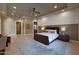 Bright main bedroom with tray ceilings, recessed lights, a ceiling fan, and tile flooring at 4714 E Lewis Ave, Phoenix, AZ 85008