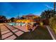 Inviting backyard pool with lush landscaping, a patio area, and ambient lighting at 4714 E Lewis Ave, Phoenix, AZ 85008