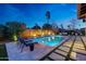 Luxurious outdoor space with a pool, comfortable seating, and lush landscaping at 4714 E Lewis Ave, Phoenix, AZ 85008
