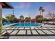 Beautiful backyard pool with water feature, landscaping, and comfortable lounge area, perfect for relaxation at 4714 E Lewis Ave, Phoenix, AZ 85008