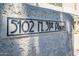 Close-up of the community address sign, featuring a unique design on a textured surface at 5102 N 31St Pl # 432, Phoenix, AZ 85016