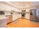 Bright kitchen with stainless steel appliances, white cabinets, and stylish checkered rug at 5102 N 31St Pl # 432, Phoenix, AZ 85016