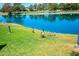 Scenic view of a pond with ducks on a lush green lawn near a golf course at 5102 N 31St Pl # 432, Phoenix, AZ 85016