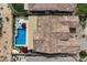 Aerial view of a home with a tile roof, pool, spa, patio, and well-maintained yard, surrounded by neighboring houses at 5621 E Lonesome Trl, Cave Creek, AZ 85331
