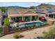 An inviting backyard with a sparkling pool, spa, covered patio, ample seating and beautiful desert landscaping at 5621 E Lonesome Trl, Cave Creek, AZ 85331