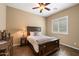 Comfortable bedroom with a wood-style bed frame, plantation shutters on the window, and a ceiling fan at 5621 E Lonesome Trl, Cave Creek, AZ 85331