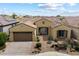 Charming single-story home featuring a tile roof, two-car garage, desert landscaping, and a welcoming front porch at 5621 E Lonesome Trl, Cave Creek, AZ 85331