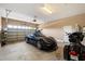 Spacious garage with epoxy floors, including a sports car and motorcycle for vehicle enthusiasts at 5621 E Lonesome Trl, Cave Creek, AZ 85331
